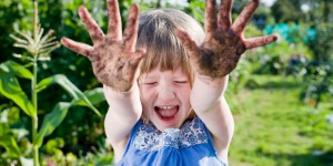 Girl(3-5) with mud hands